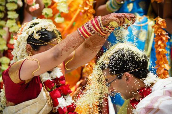 Couples throwing rice on each other