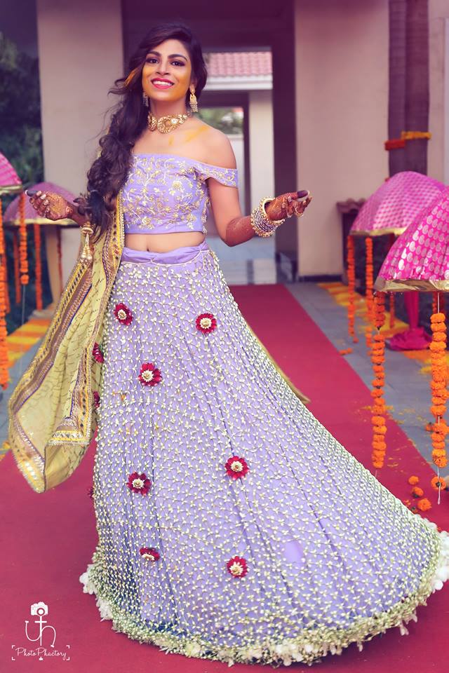 Indian bride wearing lehenga made of real flowers