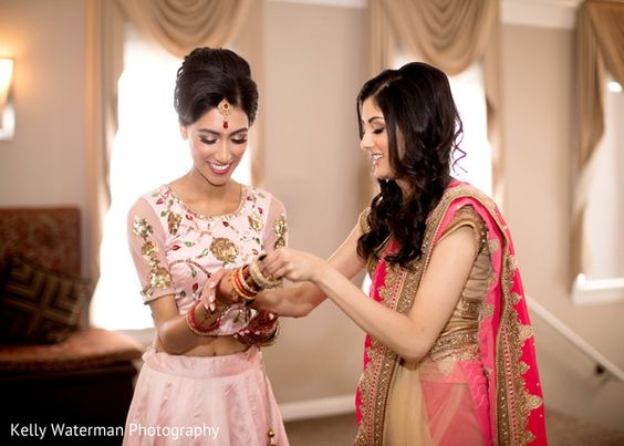 Bridesmaid helping the bride