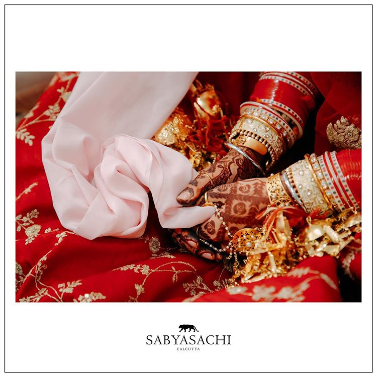 Hasleen Kaur red Sabyasachi lehenga