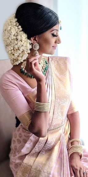 In a bridal look in a glittering maroon color pattu / kanjeevaram saree,  short sleeve blouse design, hip chain, neckl… | Indian hairstyles, Women,  Womens hairstyles